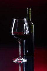 Glass and bottle of red wine.