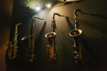 Jazz musical instrument saxophone in loft wall. Similar focus and lights.