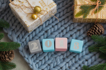 wooden cubes 2018 on a blue plaid of large mating. new year and christmas concept