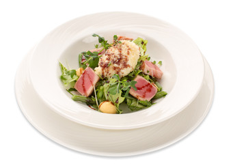 Salad of tuna, greens and green beans on a white plate