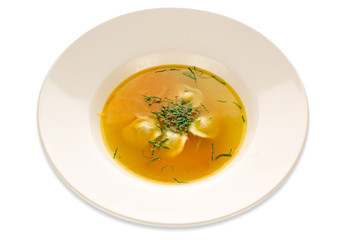 Cooked soup with greens in a white dish