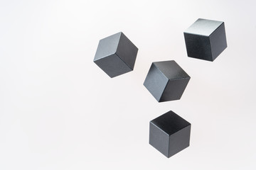 Black wooden cube shapes are floating. Concept of creative, logical thinking. Abstract geometric real floating wooden cube.
