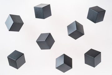 Black wooden cube shapes are floating. Concept of creative, logical thinking. Abstract geometric real floating wooden cube.