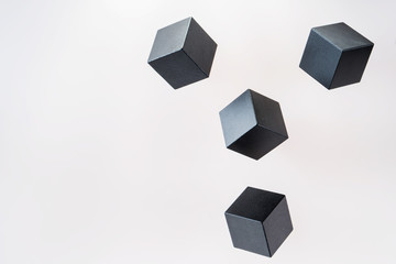 Black wooden cube shapes are floating. Concept of creative, logical thinking. Abstract geometric real floating wooden cube.
