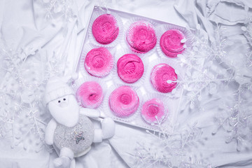 Fototapeta na wymiar Homemade pink marshmallows. zephyr on white textille background.