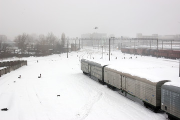 Top view of freight train with carriages on railways at winter. Selectuve focus