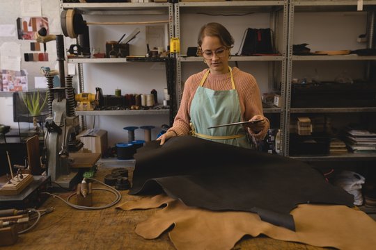 Worker using digital tablet in workshop