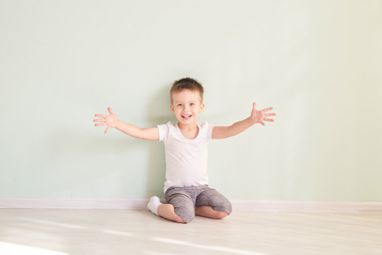 Happy Cute Child Reaching Out His Palms And Catching Something.