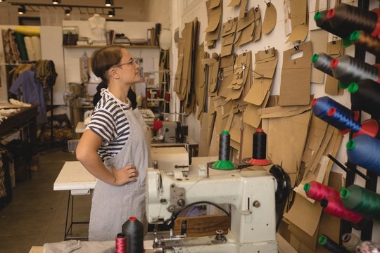 Female worker looking at leather sheets