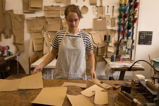 Female worker checking leather sheets
