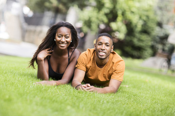 young couple lying on the grass in the park