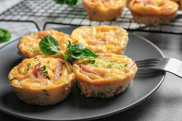 Plate with tasty egg muffins on table, closeup