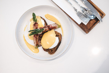 egg benedict with bacon twist asparagus