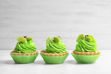 Tasty cakes on white wooden background