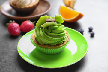 Plate with tasty cake on table