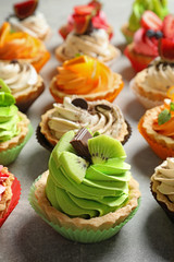 Tasty colorful cakes on table