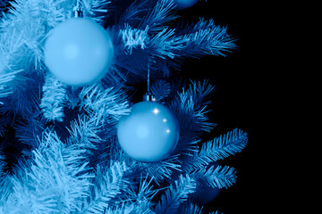 Decorated artificial white Christmas tree with white minimalistic balls