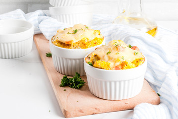 Homemade italian bread casserole strata with cheese, egg and ham, white background copy space