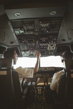 Pilot and copilot flying an airplane