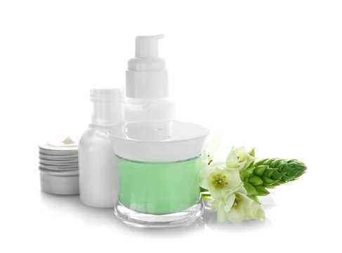 Composition with body cream and beautiful flowers on white background