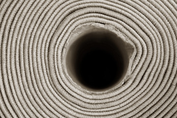 Fototapeta na wymiar Rolled carpet, closeup