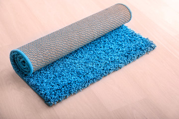 Rolled blue carpet on floor