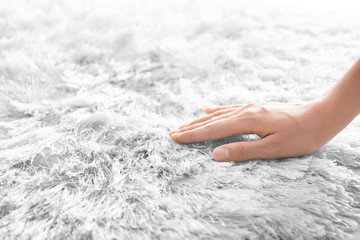 Woman touching carpet, closeup