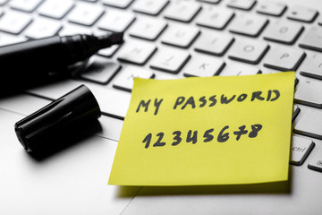 sticky note with weak easy password on laptop keyboard - obrazy, fototapety, plakaty