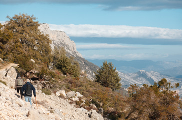 woman and man hiking in the trail to Gola su gorroppu - activity and health concept