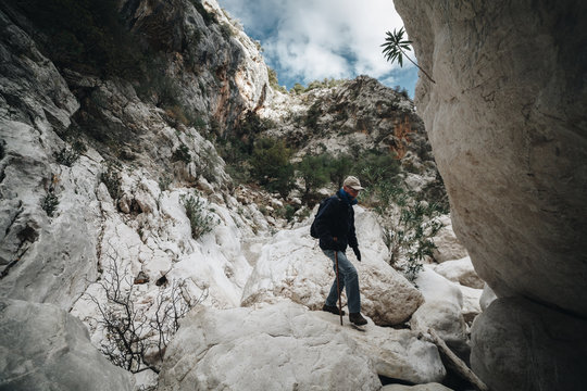 Aged Man hiking insdide the deepest canyon  in Europe - Activity and Health concept - Sardinia