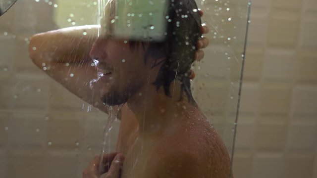 Closeup shot pf a man in a shower. Focus on a man