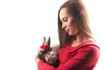 photo of a girl who holds a rabbit on her hands