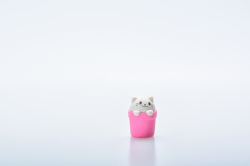 Colorful rubber cat icon isolated on white background. Concept of cuteness and element of surprise . Isolated on white background. Slightly de-focused and close-up shot. Copy space.