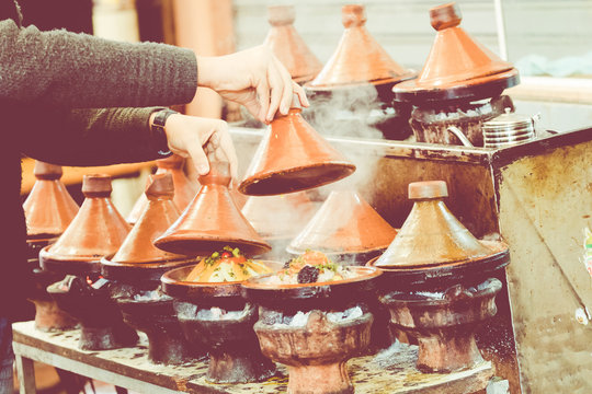 Cooking traditional Moroccan dish, meat and vegetable in ceramic tajine in Marrakech in Morocco.