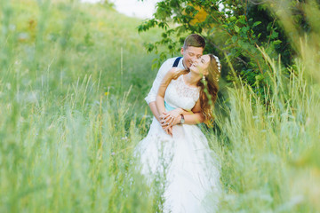 the bride and groom are photographed on the nature