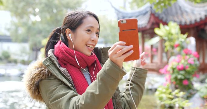 Woman making video call on smart phone in china
