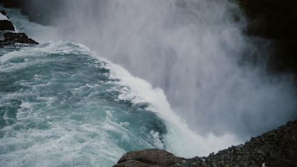 Fototapeta na wymiar Beautiful scenic landscape of the Gullfoss waterfall in Iceland. Splashing water falling down from the cliff with foam.