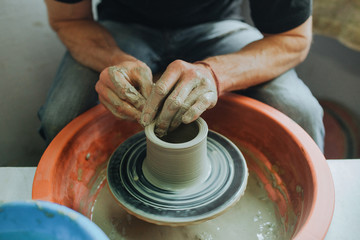 Potter molds on potters wheel close-up