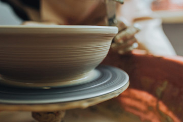 Process of making clay bowl on pottery wheel