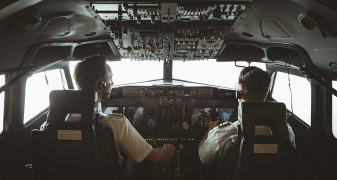 Pilot and copilot flying an airplane