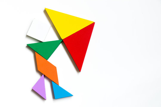 Colorwood tangram puzzle on human hold the umbrella shape on white background (Concept for business face the crisis)