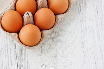 Yellow chicken eggs in package
