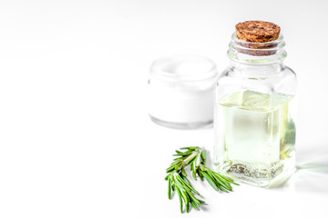 organic cosmetics with extracts of herbs rosemary on white backg