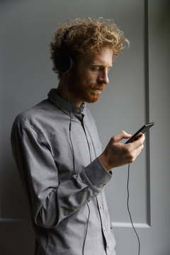 Man using cell phone while listening to music