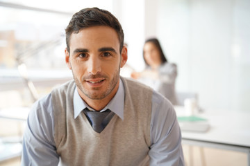 Portrait of young businessman looking at camera