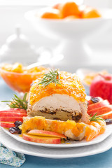 Baked meatloaf stuffed with apples and plums, decorated tangerine confiture. Christmas menu