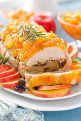 Baked meatloaf stuffed with apples and plums, decorated tangerine confiture. Christmas menu