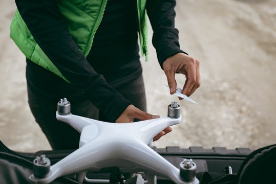 Woman installing propeller of drone before take off