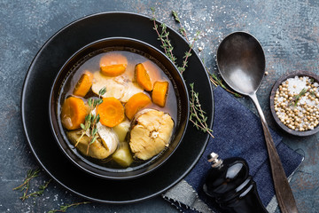 Delicious fresh fish soup with hake in bowl on table. Top view