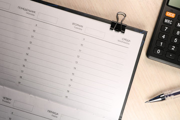 Notepad for notes on a wooden background. Daily log.